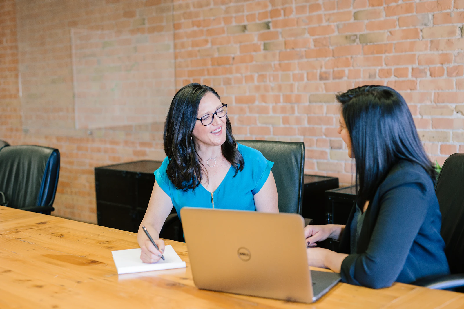 Two professionals collaborating on a software decision at a meeting table