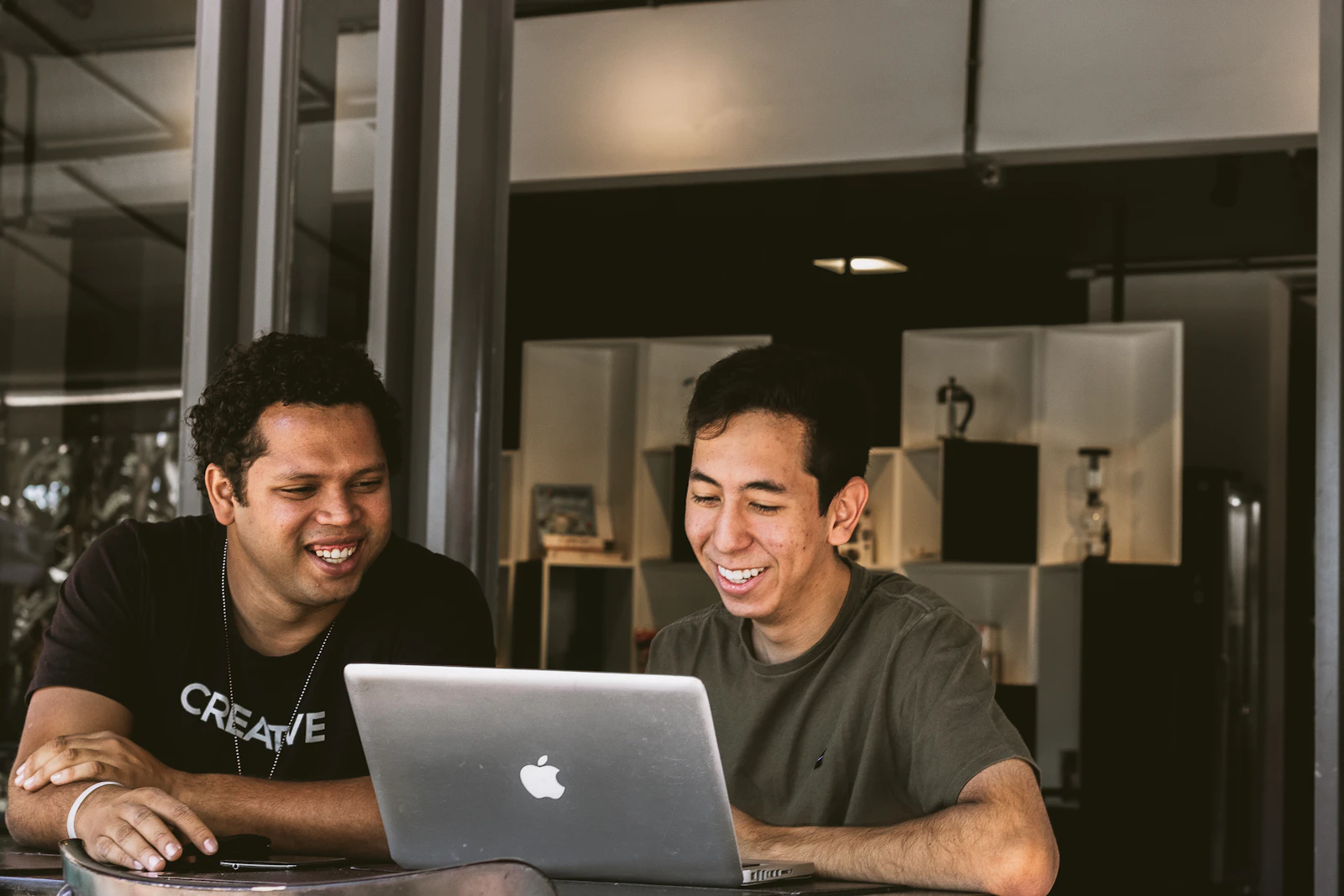 Two small business teammates reviewing an AI tool together on a laptop